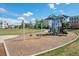 Neighborhood playground with swings, slide, and play structure on a green lawn offers fun for families at 9446 E 51St Dr, Denver, CO 80238