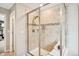 Stylish walk-in shower with tiled walls and a built-in seat at 9446 E 51St Dr, Denver, CO 80238