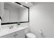 Neutral bathroom with a white vanity, toilet, and a large framed mirror at 14247 Pikeminnow Pl, Broomfield, CO 80023
