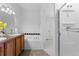 Bright bathroom featuring a soaking tub with tile surround and a separate glass-enclosed shower at 14247 Pikeminnow Pl, Broomfield, CO 80023