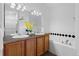 Updated bathroom with double sinks, oak cabinets, and a shower/tub combo at 14247 Pikeminnow Pl, Broomfield, CO 80023