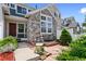 Charming townhouse with stone accents, a cozy patio, and meticulous landscaping at 14247 Pikeminnow Pl, Broomfield, CO 80023