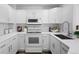 Bright white kitchen with modern appliances and stylish subway tile backsplash at 14247 Pikeminnow Pl, Broomfield, CO 80023