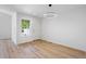 Bright, open living space with wood floors and a modern light fixture at 14247 Pikeminnow Pl, Broomfield, CO 80023