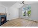 Bright living room features a fireplace, fan, and large windows overlooking the yard at 14247 Pikeminnow Pl, Broomfield, CO 80023