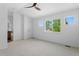 Spacious main bedroom with ceiling fan and a doorway to the ensuite bathroom at 14247 Pikeminnow Pl, Broomfield, CO 80023