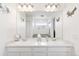 Bright and airy bathroom with double vanity, large mirror, and decorative sea-themed accents at 4280 Pioneer Pl, Brighton, CO 80601