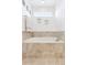 Relaxing bathroom with a soaking tub, neutral tile surround, and a bright window at 4280 Pioneer Pl, Brighton, CO 80601