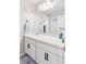 Bathroom featuring a white vanity with a large mirror, ample storage, and a modern faucet at 4280 Pioneer Pl, Brighton, CO 80601