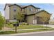 Well-maintained two-story home with green siding, a manicured lawn, and mature landscaping at 4280 Pioneer Pl, Brighton, CO 80601