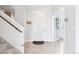 Inviting foyer with hardwood floors, a staircase, and a view into another room at 4280 Pioneer Pl, Brighton, CO 80601