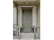 Charming front porch with a neutral-colored front door, plants and comfortable seating at 4280 Pioneer Pl, Brighton, CO 80601