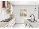 Bright kitchen featuring an island, gas cooktop, stainless steel appliances, and backyard view at 4280 Pioneer Pl, Brighton, CO 80601
