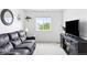 Comfortable living room with a plush couch, entertainment center, and large window with a backyard view at 4280 Pioneer Pl, Brighton, CO 80601