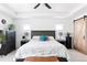 Spacious main bedroom featuring a tray ceiling, barn door access, and a calming, neutral color scheme at 4280 Pioneer Pl, Brighton, CO 80601
