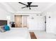 Bright main bedroom with a barn door, a ceiling fan, and plenty of natural light at 4280 Pioneer Pl, Brighton, CO 80601