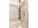 Shower features tiled walls, a built-in bench, and a shower caddy at 4280 Pioneer Pl, Brighton, CO 80601