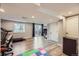 Finished basement space with wood-look floors, large window, and access to backyard at 9624 Crosspointe Dr, Highlands Ranch, CO 80130