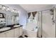 Well-lit bathroom featuring double sinks, a soaking tub, a separate shower, and a window with natural light at 9624 Crosspointe Dr, Highlands Ranch, CO 80130