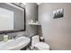 Tastefully designed powder room features modern fixtures and grey paint at 9624 Crosspointe Dr, Highlands Ranch, CO 80130