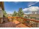 View from deck with wooden railing showcasing neighborhood and sky at 9624 Crosspointe Dr, Highlands Ranch, CO 80130