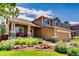 Charming two-story home boasts a lovely front porch and well-manicured landscaping at 9624 Crosspointe Dr, Highlands Ranch, CO 80130