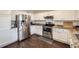 Well-equipped kitchen features stainless steel appliances, granite counters, and white cabinetry at 9624 Crosspointe Dr, Highlands Ranch, CO 80130