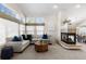 Inviting living room featuring a fireplace, comfortable seating, and ample natural light at 47 Herrn Ln, Castle Pines, CO 80108