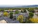 High-angle view of community with well-maintained homes surrounded by mature trees and mountain views at 1670 S Deframe St # C2, Lakewood, CO 80228