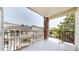 Open-air balcony featuring brick pillars and wrought iron railings overlooking well-maintained grounds at 1670 S Deframe St # C2, Lakewood, CO 80228