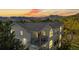 Charming multi-level home with mountain views, balconies, and arched windows at sunset at 1670 S Deframe St # C2, Lakewood, CO 80228