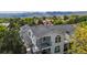 Charming multi-level home with mountain views, balconies, and arched windows surrounded by trees at 1670 S Deframe St # C2, Lakewood, CO 80228
