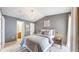 Calm main bedroom with a large bed, soft lighting, and ensuite bathroom access at 1670 S Deframe St # C2, Lakewood, CO 80228