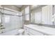 Bright bathroom featuring a shower over tub, white vanity with ample storage, and tile accents at 11829 Deorio St, Parker, CO 80134