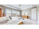 Bright and airy main bedroom featuring neutral walls, large windows, and tray ceiling at 11829 Deorio St, Parker, CO 80134