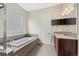 Bathroom features a soaking tub, double vanity, and a large window at 15994 La Plata Peak Pl, Broomfield, CO 80023