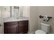 Powder room with granite countertop and dark wood cabinets at 15994 La Plata Peak Pl, Broomfield, CO 80023