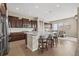 Modern kitchen with granite countertops, dark wood cabinets, and island with seating at 15994 La Plata Peak Pl, Broomfield, CO 80023