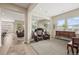 Spacious living room with leather chairs, large windows and ample natural light at 15994 La Plata Peak Pl, Broomfield, CO 80023