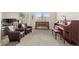 Living room with two leather armchairs, piano, and a beautiful wooden cabinet at 15994 La Plata Peak Pl, Broomfield, CO 80023