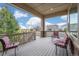 Relaxing covered porch with seating area and neighborhood views at 15994 La Plata Peak Pl, Broomfield, CO 80023