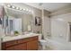 Well-lit bathroom with vanity, toilet, shower and tub is both practical and inviting at 5134 S Fraser Way, Aurora, CO 80015