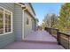 Wide deck that runs along the side of the house with railing that matches the trim at 5134 S Fraser Way, Aurora, CO 80015