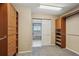 Walk-in closet featuring custom wood shelving and drawers next to a bathroom with a large soaking tub at 5134 S Fraser Way, Aurora, CO 80015