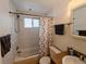 A clean bathroom with a shower and curtain with a sink at 1135 N Elizabeth St # 102, Denver, CO 80206