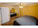 Cozy bedroom features a ceiling fan, carpeted floor, and mirrored closet doors at 1135 N Elizabeth St # 102, Denver, CO 80206