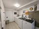 Well-lit laundry room with modern washing machines and tile flooring in the basement at 1135 N Elizabeth St # 102, Denver, CO 80206