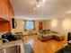 Living room with a hardwood floor, and a couch with a window at 1135 N Elizabeth St # 102, Denver, CO 80206