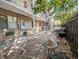Community patio area for residents with mature landscaping and furniture at 1135 N Elizabeth St # 102, Denver, CO 80206
