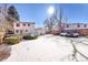 Snow-covered backyard with a view of the house and fence at 17009 E Loyola Pl, Aurora, CO 80013